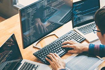 cyber security student working at a computer