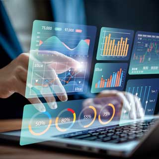 Hands using a laptop keyboard and pointing to holographic charts that float in front of the computer screen, demonstrating AI and the future of work. 